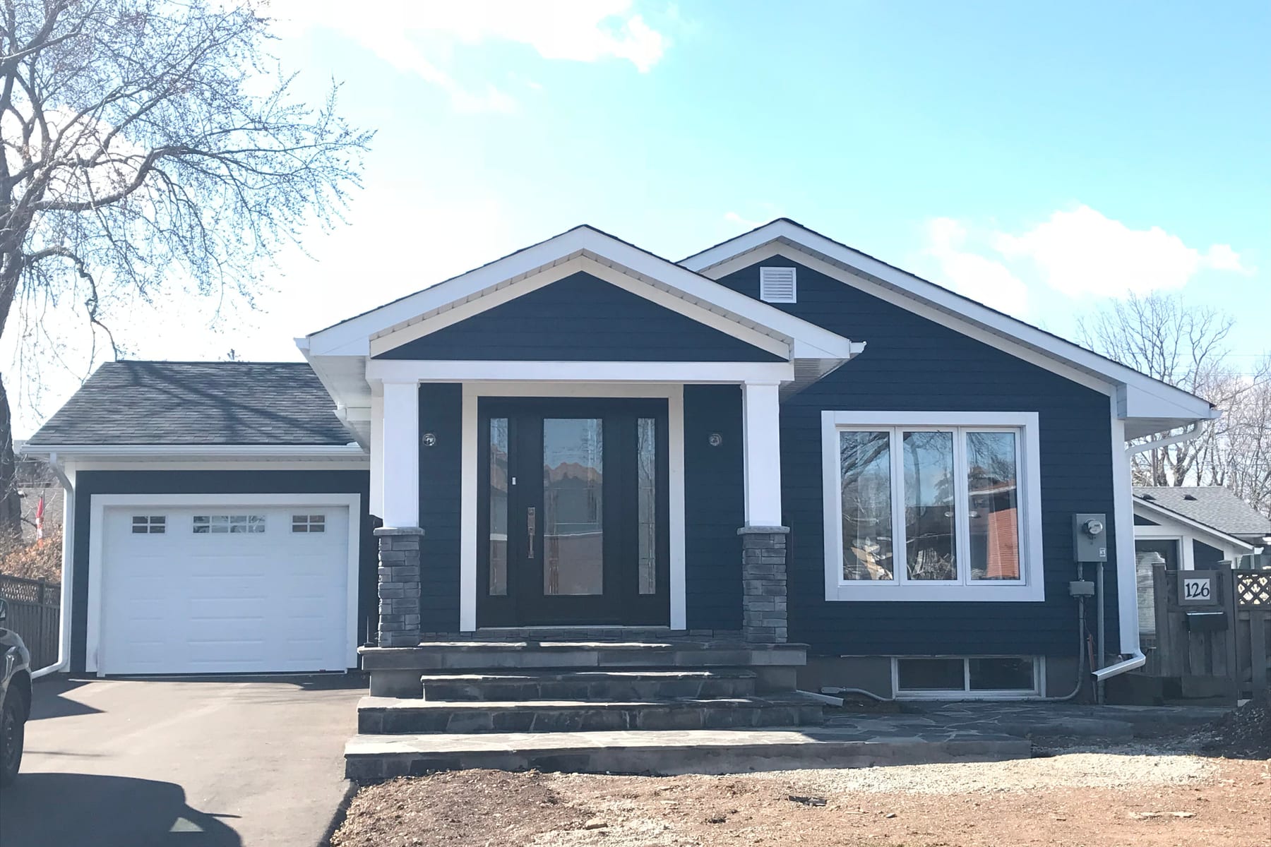 Finished bungalow with seamless eavestroughs and white trim